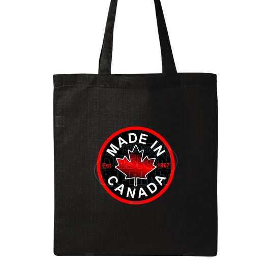 15x16" solid black canvas tote bag with Circular design with Made in Canada & a centered bright red maple leaf & Est.1867